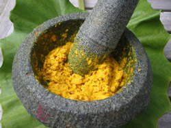 yellow naturopath concoction in a mortar and pestle 